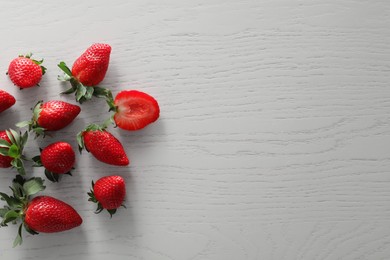 Food photography. Delicious ripe strawberries on white wooden table, flat lay with space for text