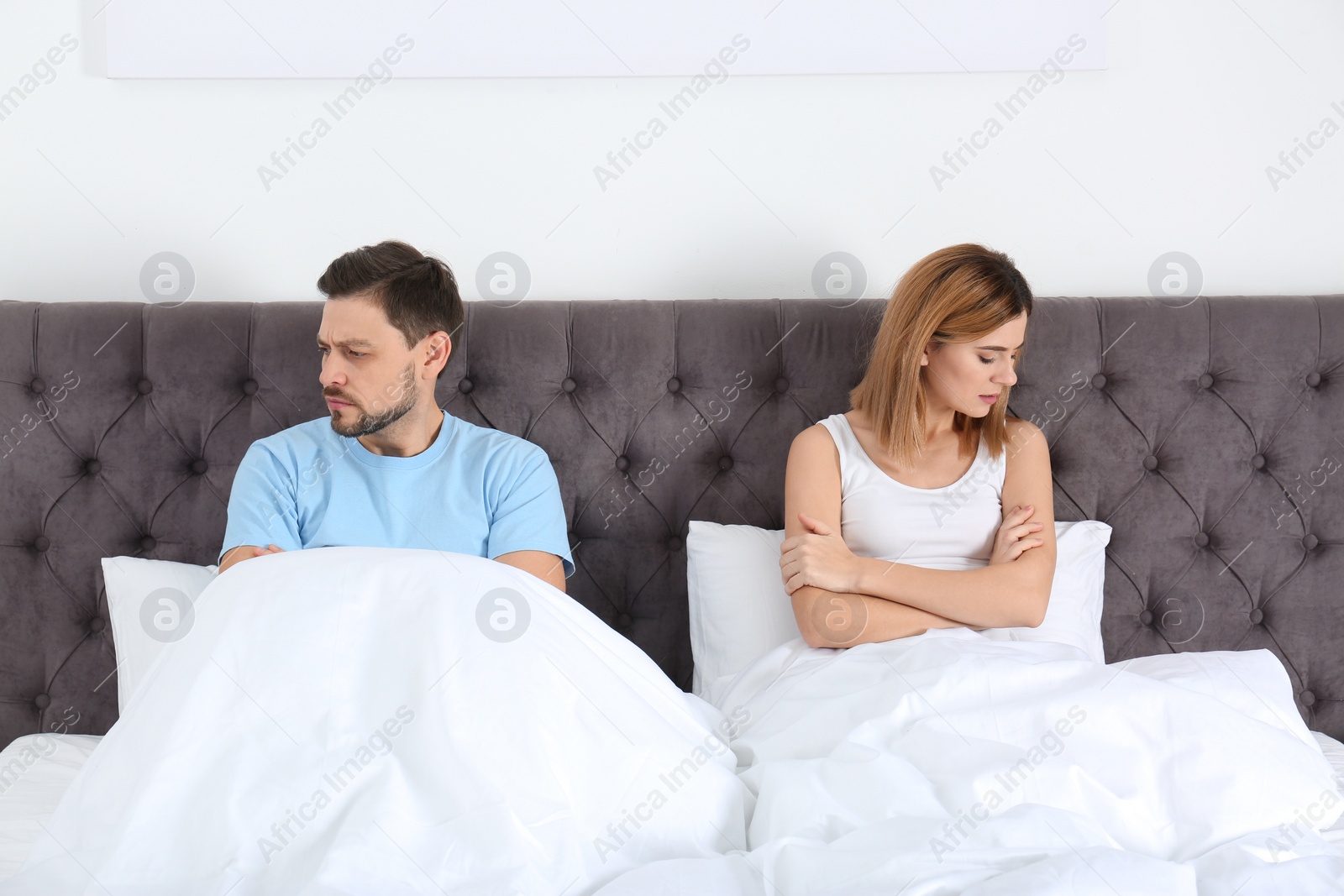 Photo of Couple with relationship problems ignoring each other in bedroom