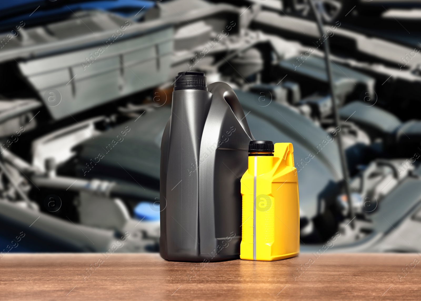 Image of Motor oil in different containers on wooden table