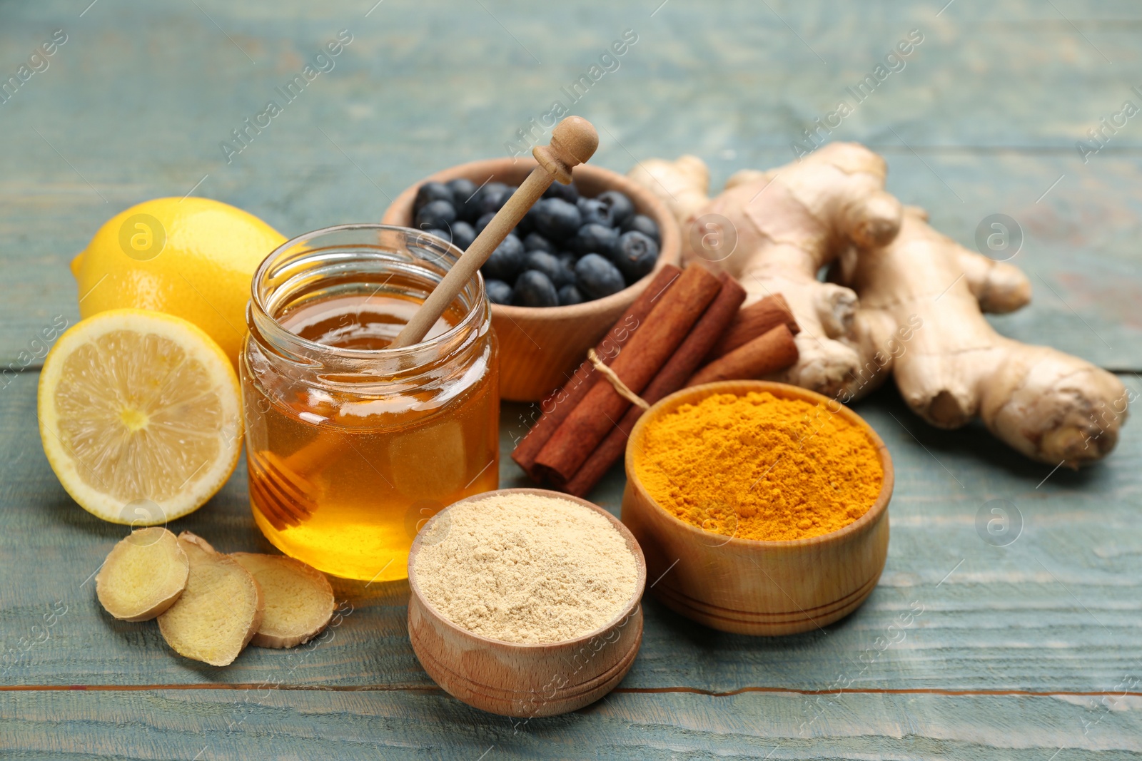 Photo of Different fresh products on light blue wooden table. Natural antibiotics