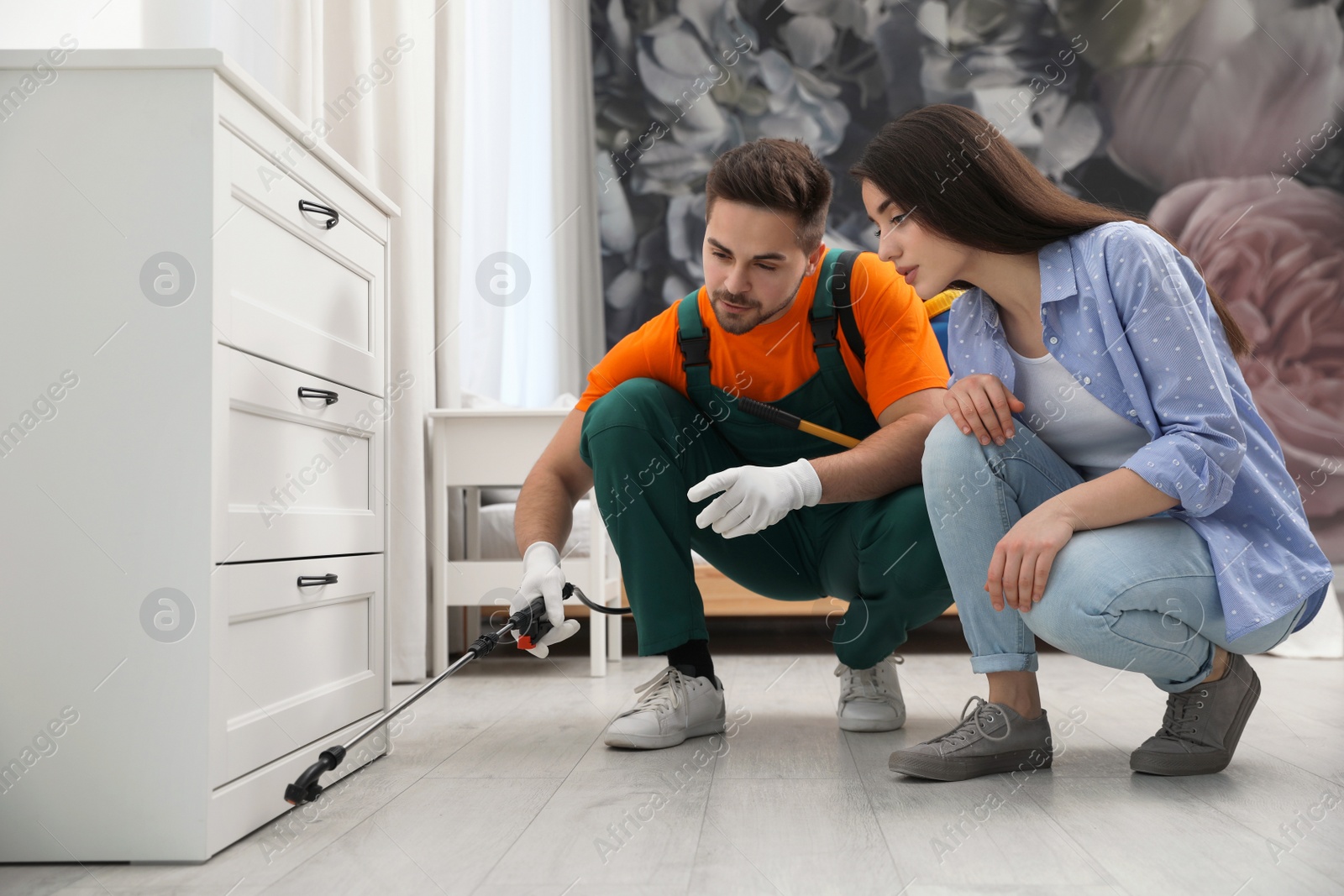 Photo of Woman showing insect traces to pest control worker at home