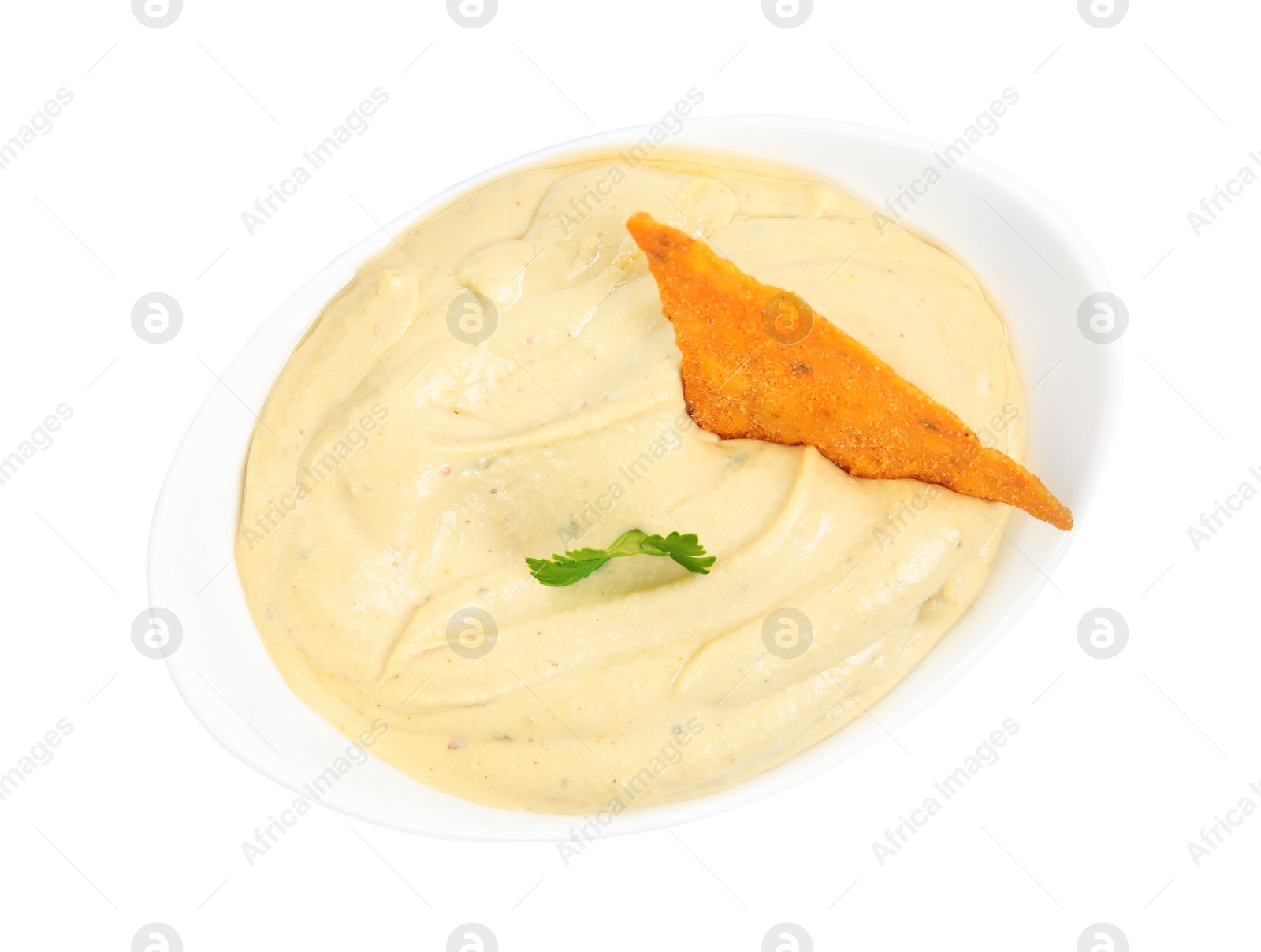 Photo of Delicious hummus with nacho chip and parsley in bowl isolated on white, top view