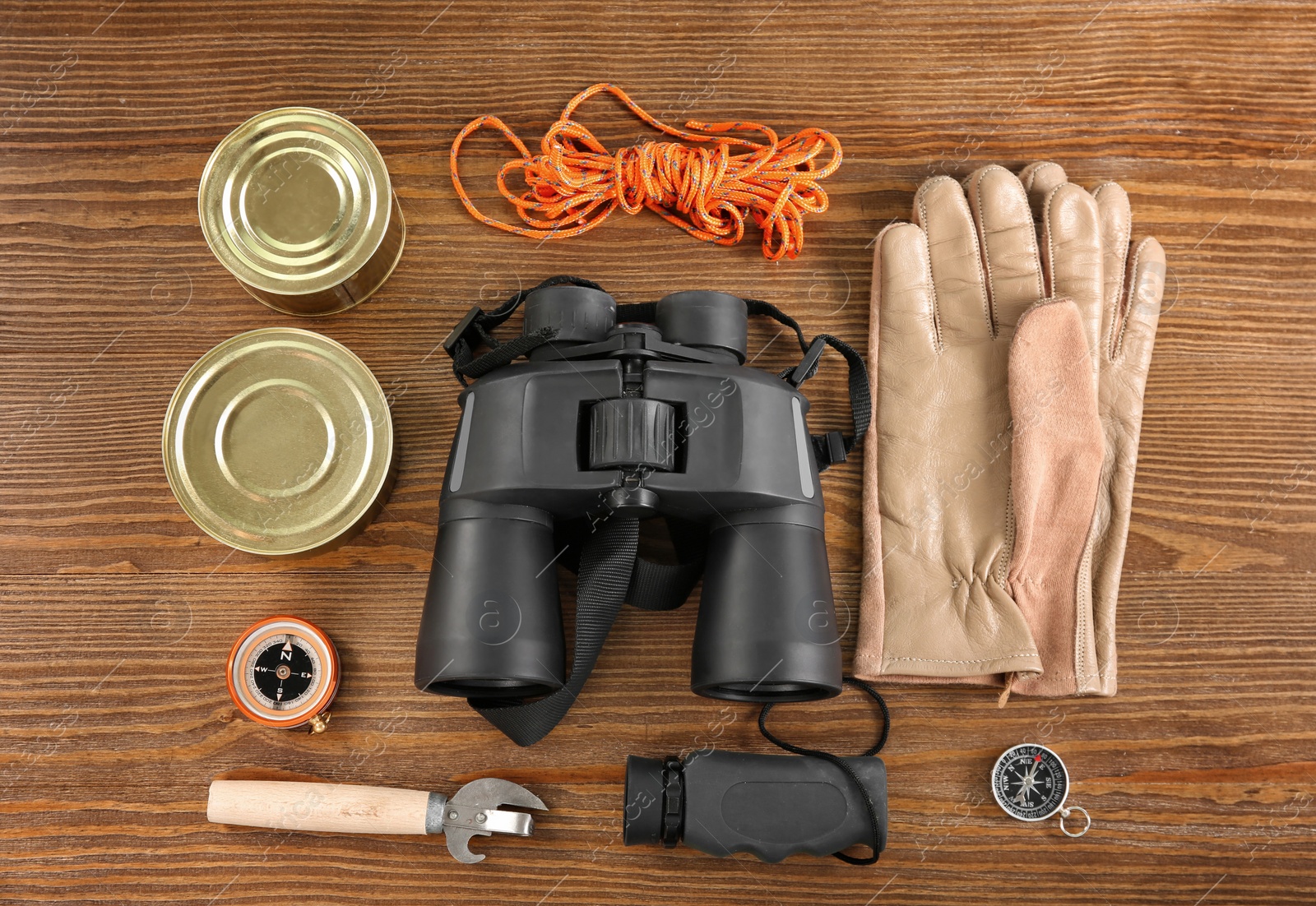 Photo of Flat lay composition with camping equipment on wooden background