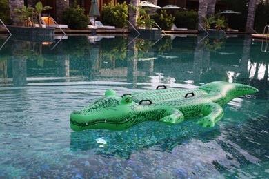 Photo of Float in shape of crocodile in swimming pool at luxury resort