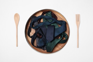 Photo of Creative business lunch layout. Plate with ties, and cutlery on white background