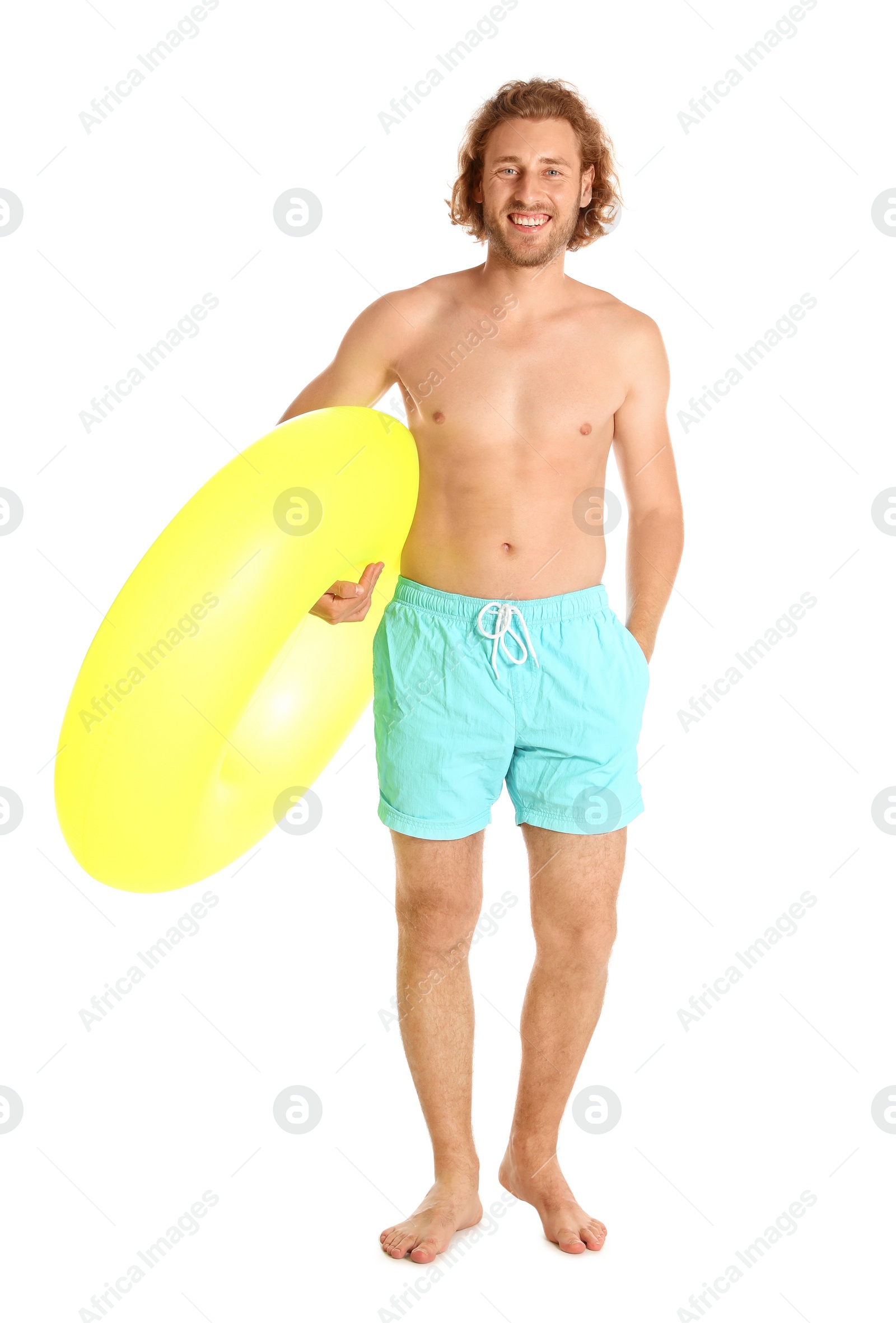 Photo of Attractive young man in swimwear with yellow inflatable ring on white background