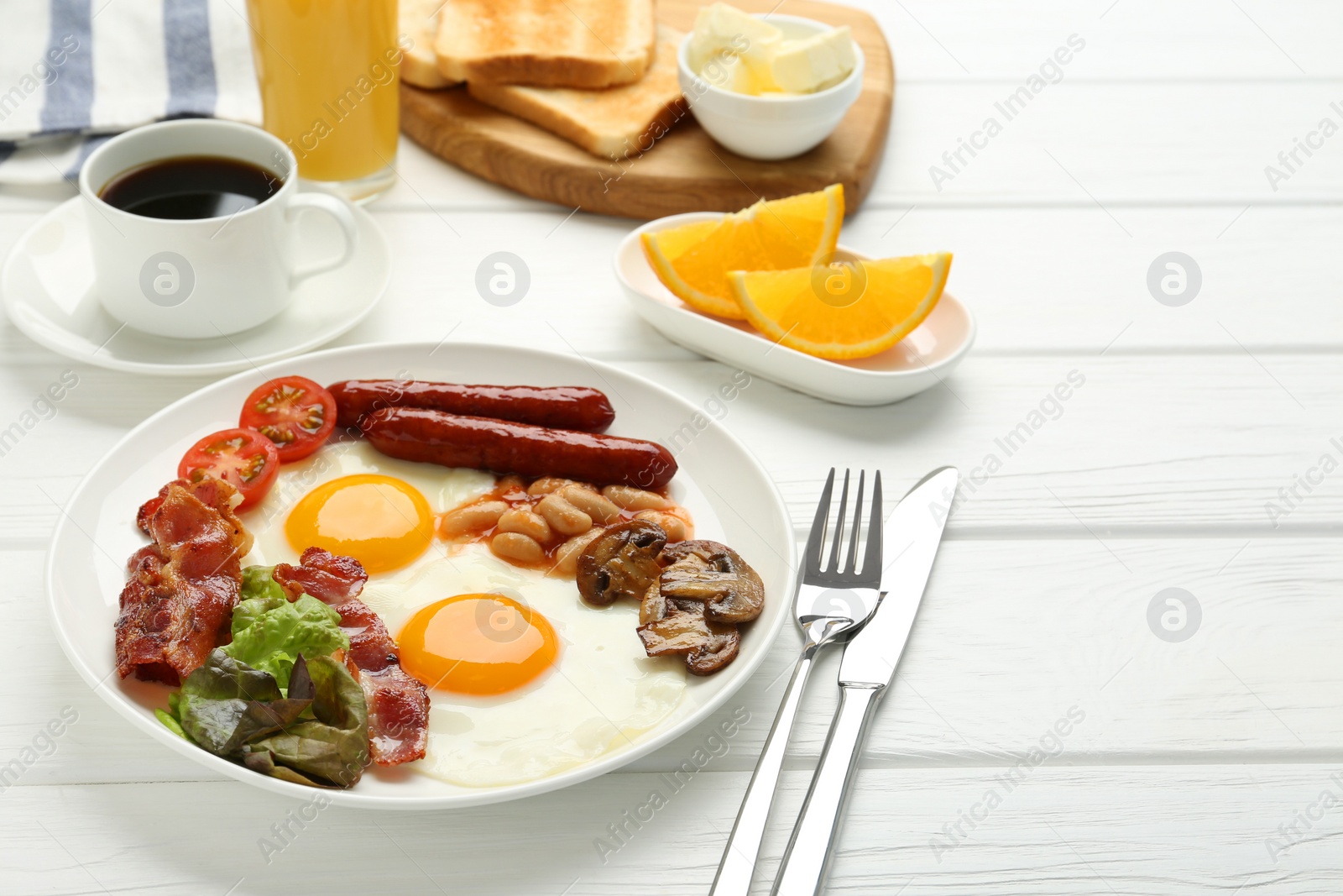 Photo of Delicious breakfast with sunny side up eggs served on white wooden table