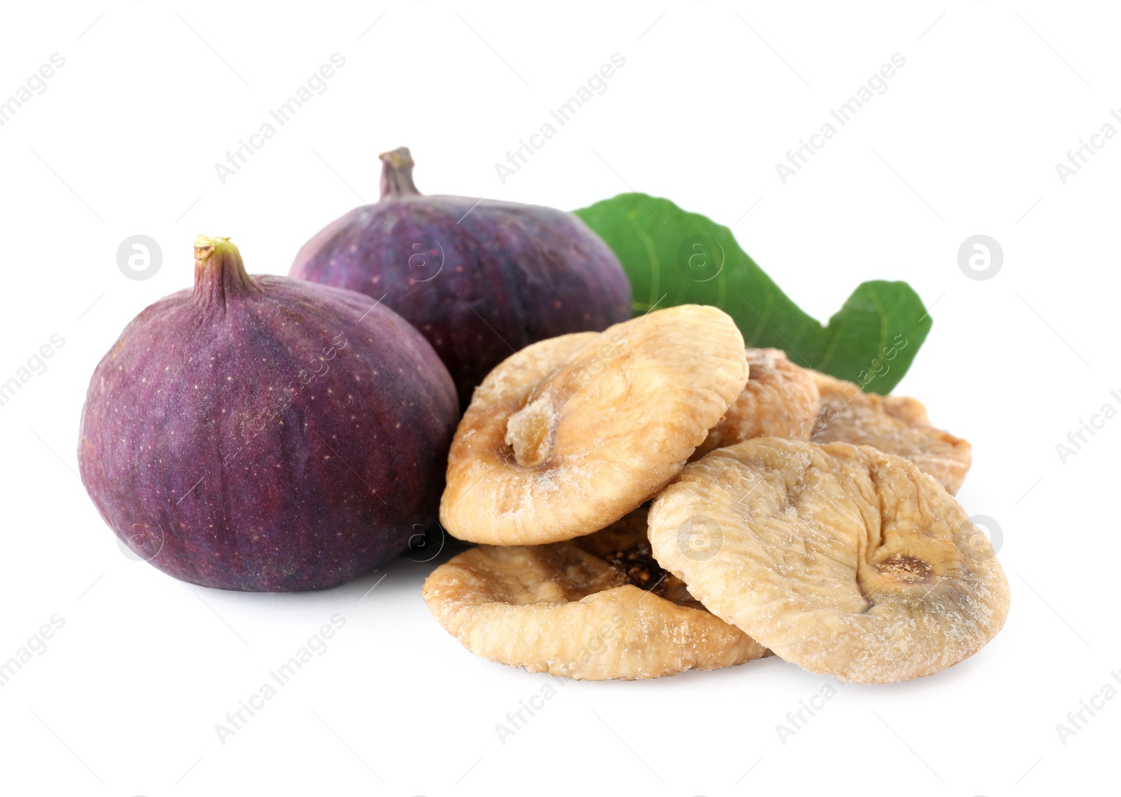 Photo of Tasty dried and raw figs with leaf on white background