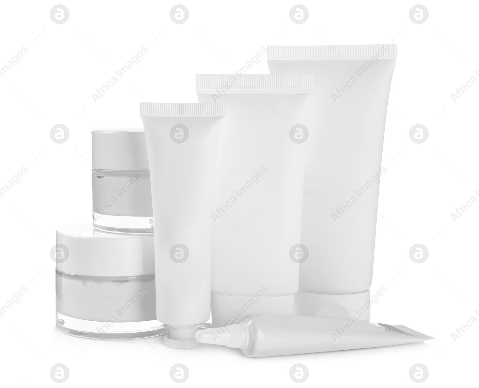 Photo of Blank tubes and jars of cosmetic products on white background