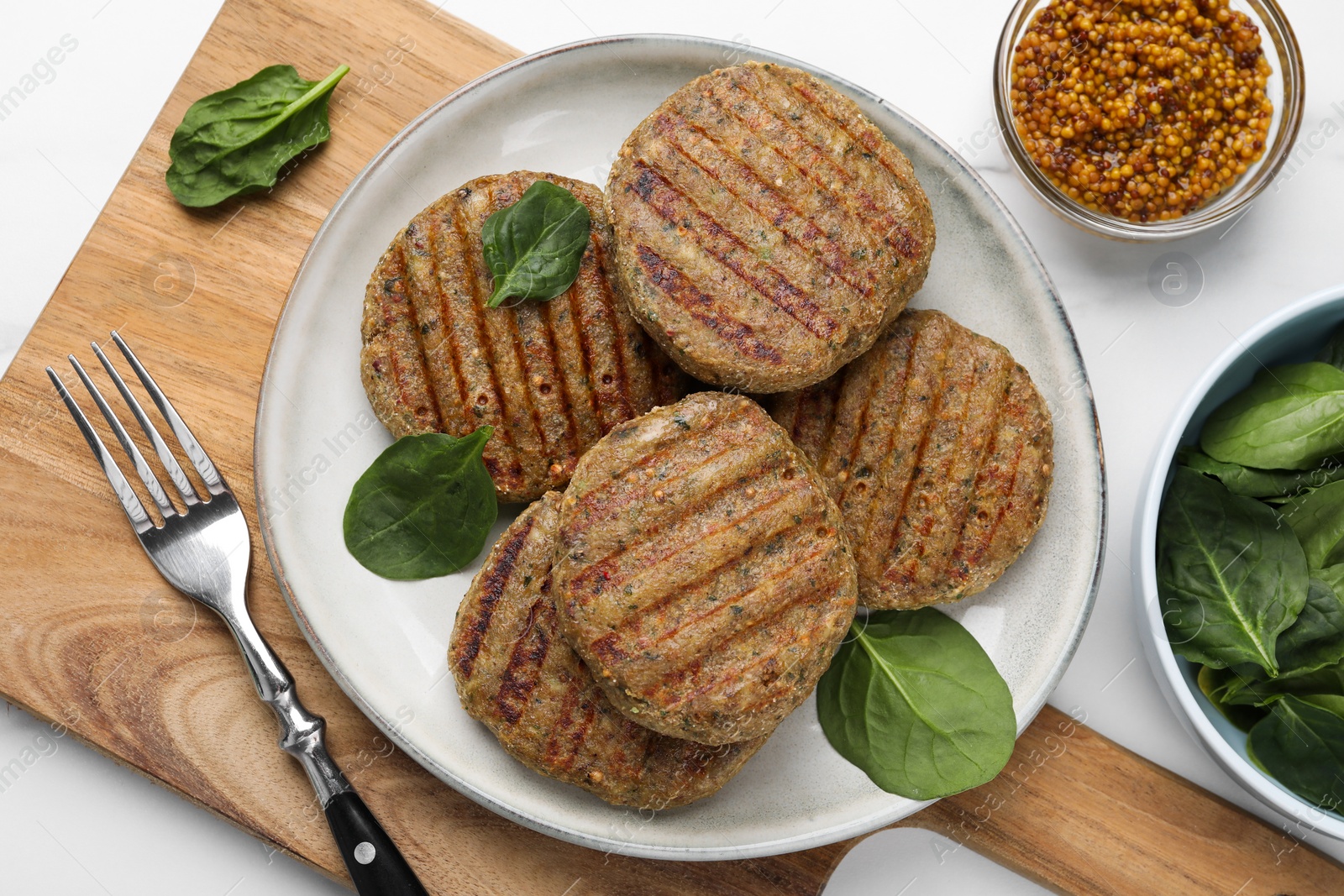 Photo of Tasty grilled vegan cutlets served on white table, flat lay