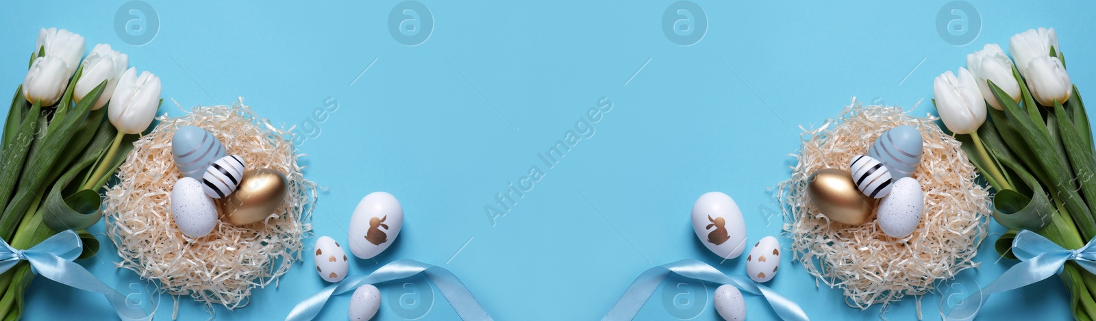Image of Flat lay composition with decorated Easter eggs and flowers on light blue background, space for text. Banner design