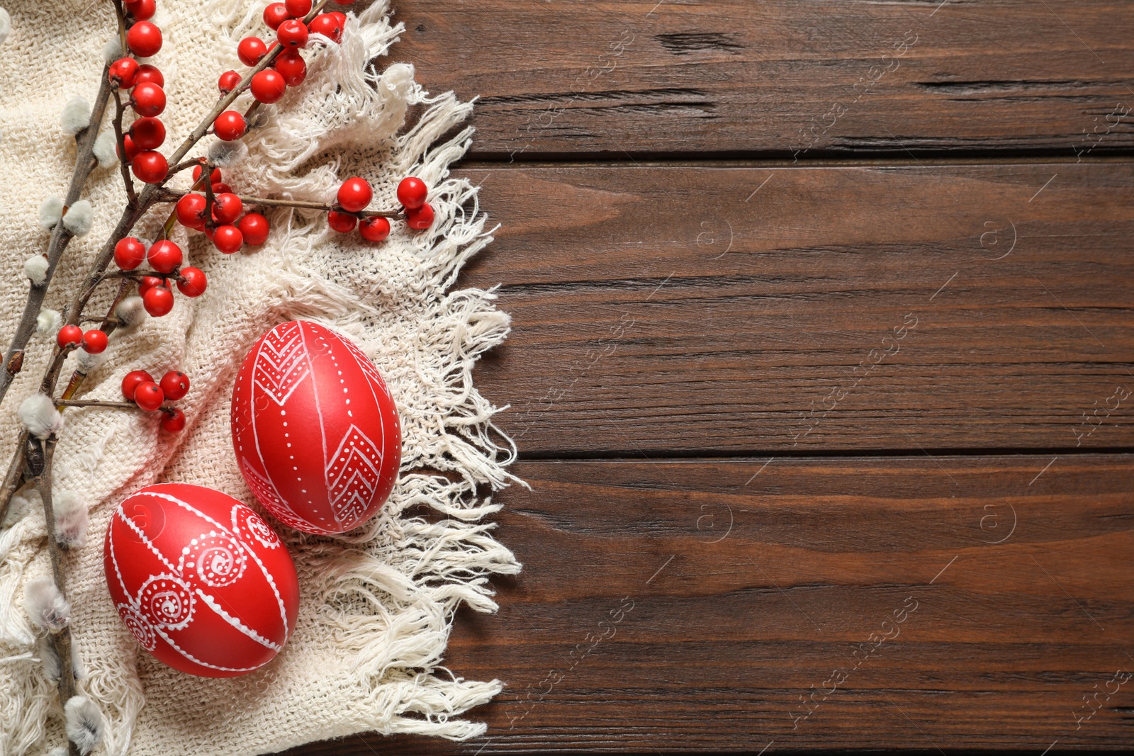 Photo of Flat lay composition with painted red Easter eggs on wooden table, space for text