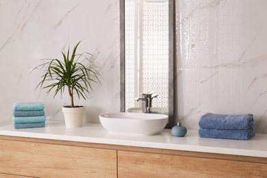 Modern mirror and vessel sink in stylish bathroom