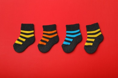 Cute child socks on color background, flat lay