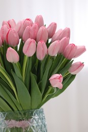Photo of Bouquet of beautiful pink tulips on blurred background, closeup