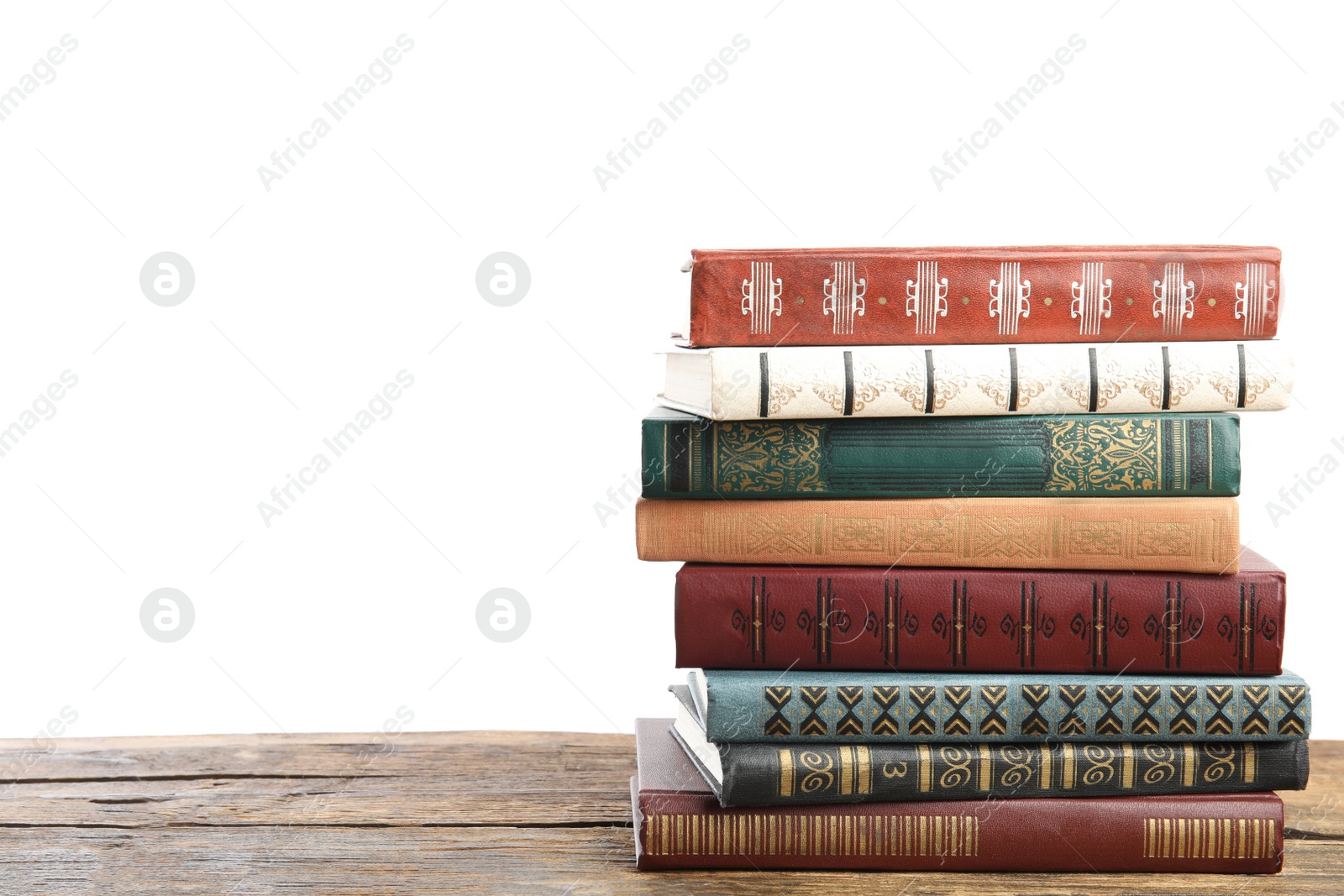 Photo of Stack of old vintage books on wooden table against white background