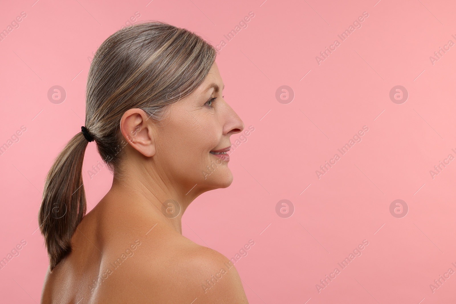 Photo of Beautiful woman with healthy skin on pink background, space for text