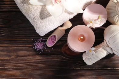 Photo of Composition with spa supplies and flowers on wooden table, flat lay. Space for text