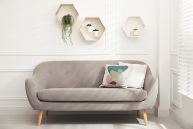 Image of Soft pillow with stylish abstract print on sofa indoors