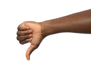 Photo of African-American man showing thumb down gesture on white background, closeup