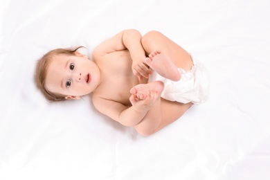 Cute little baby lying on white background, top view