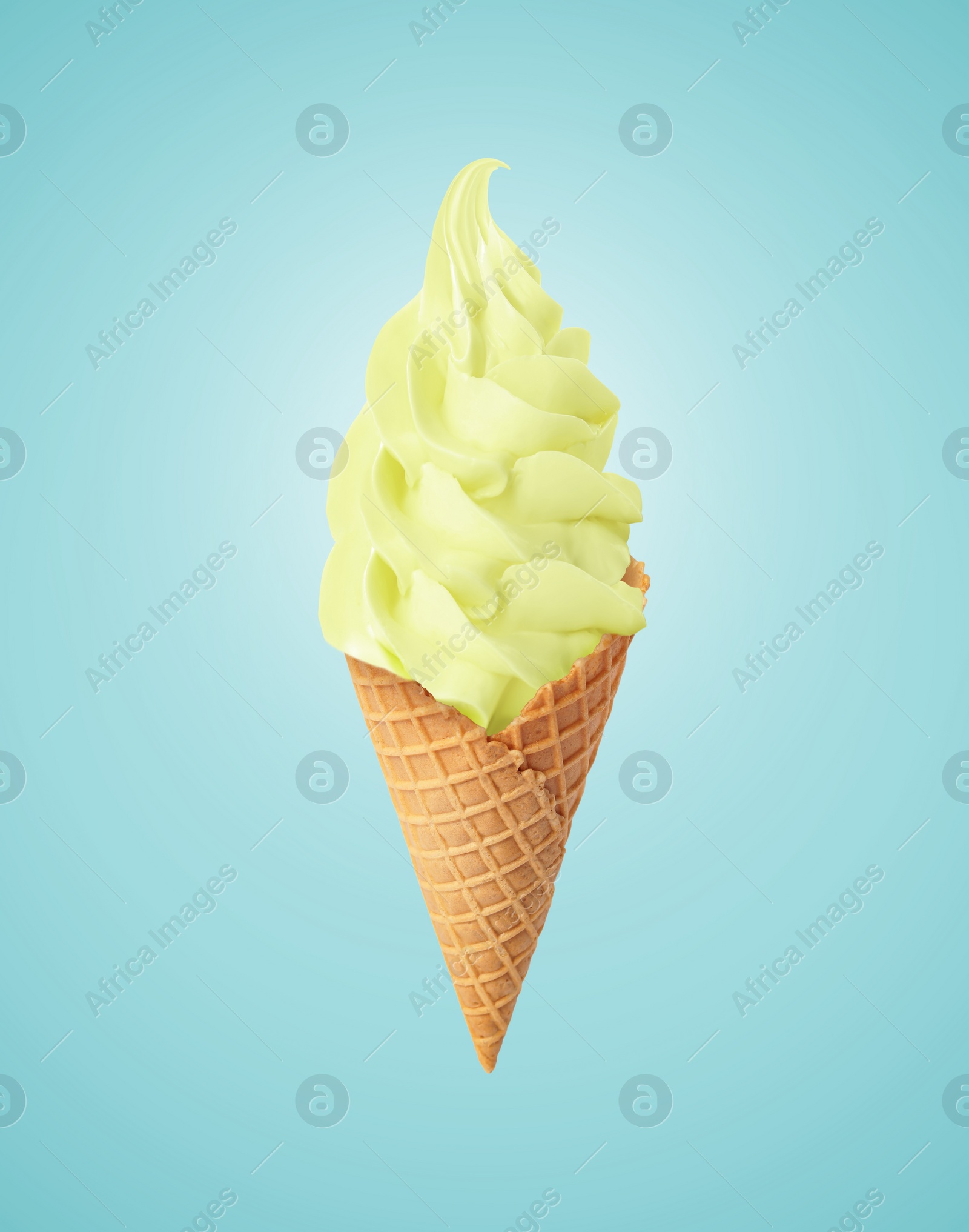 Image of Tasty ice cream in waffle cone on pastel light blue background. Soft serve