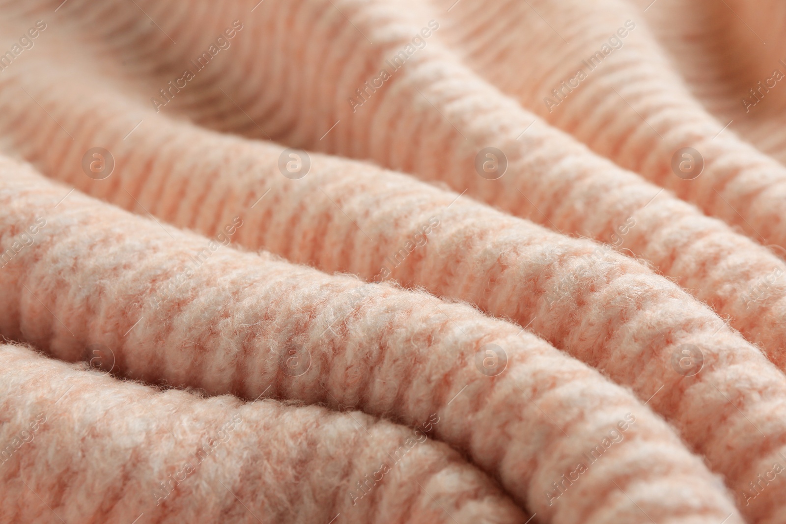 Photo of Beautiful pale pink knitted fabric as background, closeup