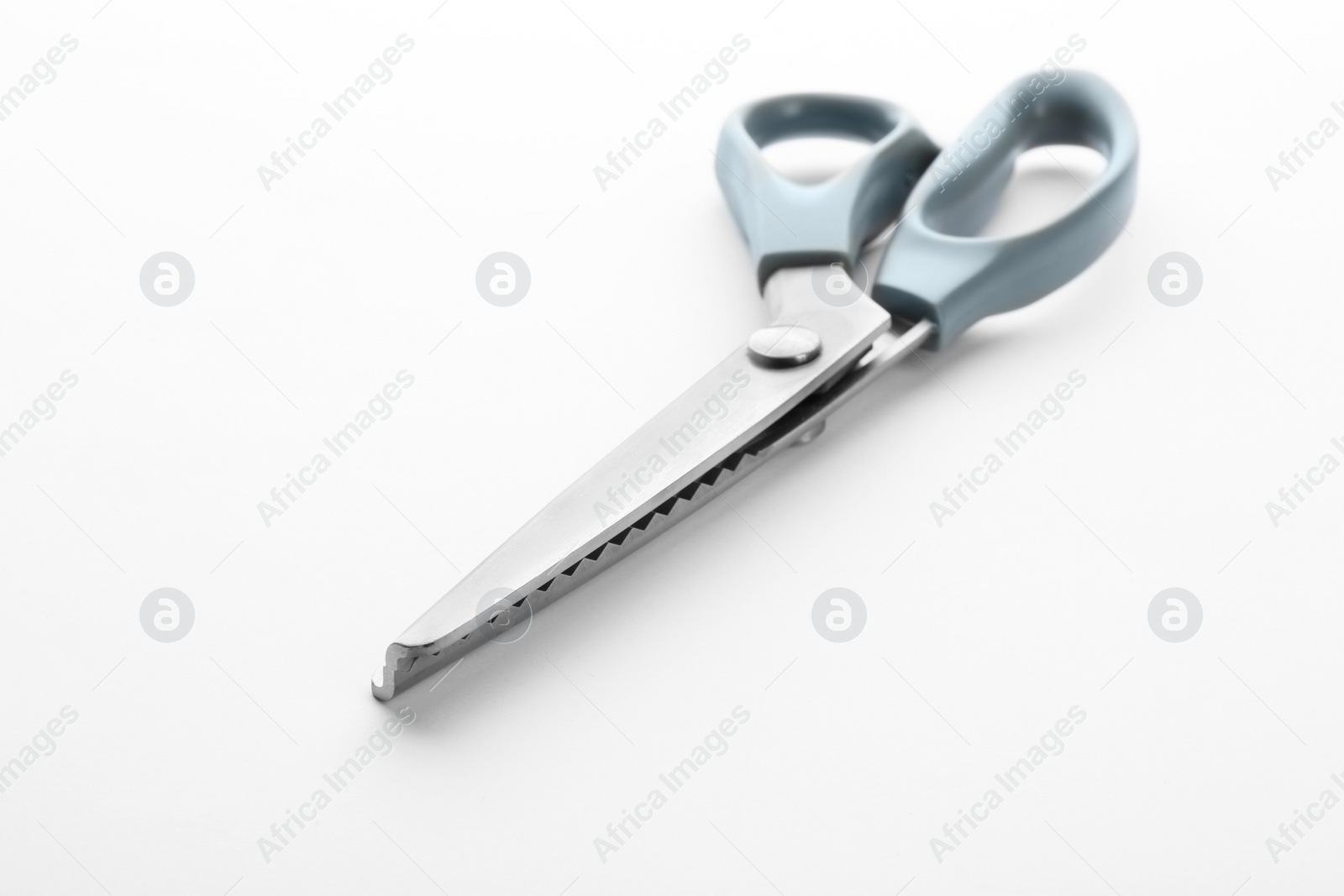 Photo of Pair of sewing scissors on white background