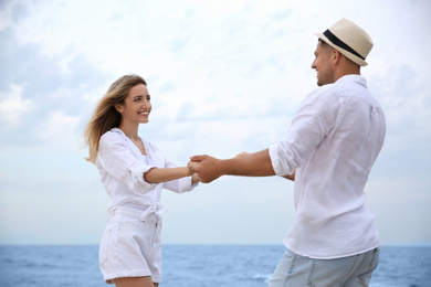 Happy couple having romantic walk on beach