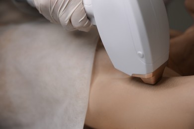 Photo of Woman undergoing laser epilation procedure, closeup view