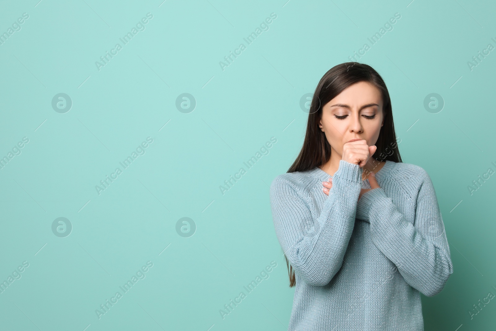 Photo of Young woman coughing on color background