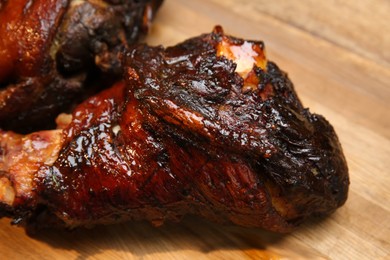 Photo of Delicious roasted pork foreshanks on wooden board, closeup