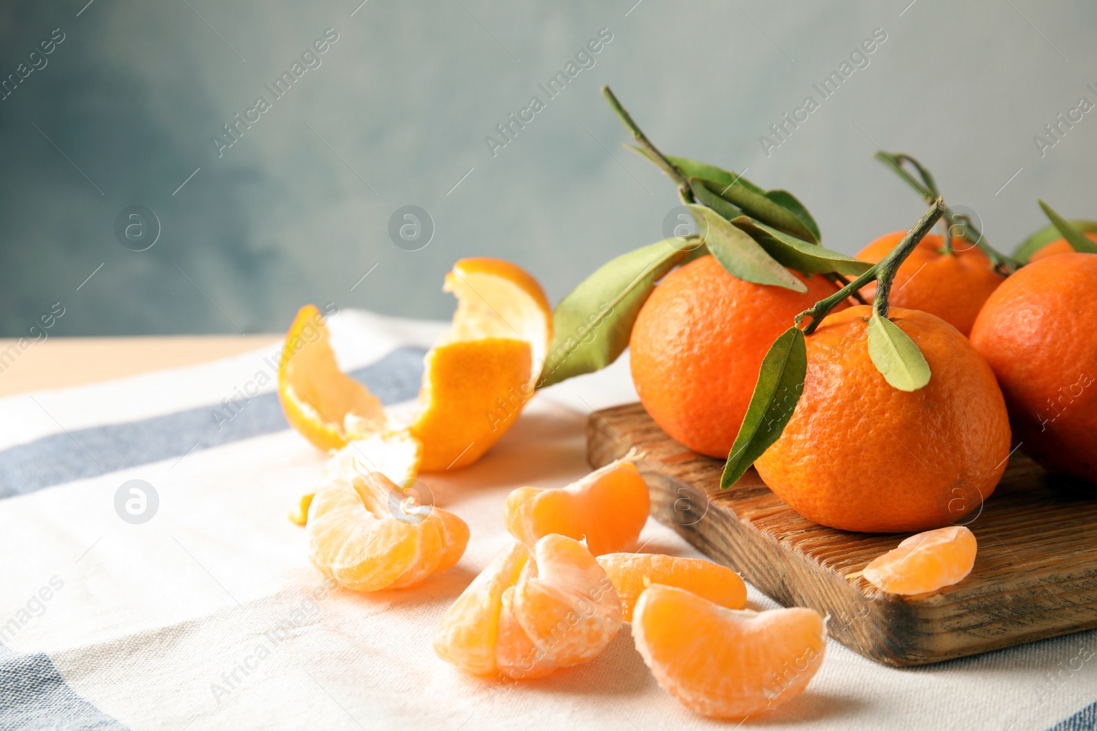 Photo of Ripe tangerines on table. Space for text