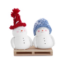 Photo of Cute decorative snowmen in color hats isolated on white