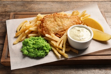 British traditional fish and potato chips on wooden table