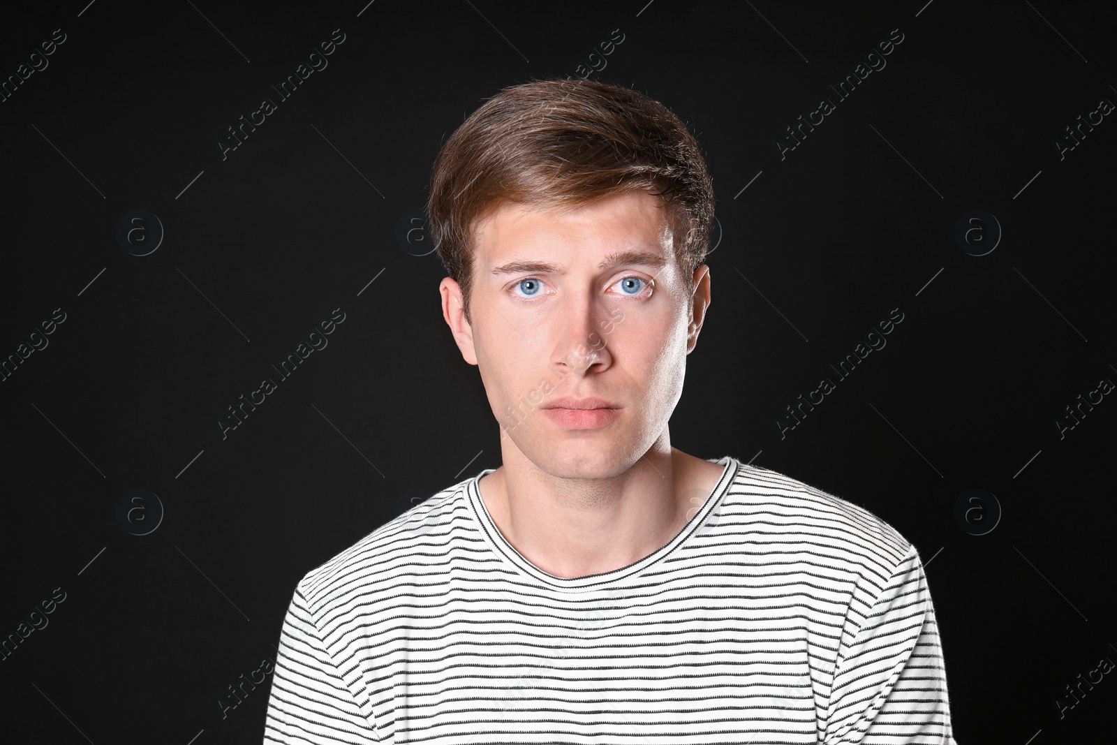Photo of Portrait of handsome man on black background
