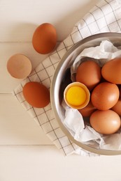 Fresh raw chicken eggs on white wooden table, flat lay