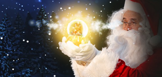 Image of Santa Claus with glowing snow globe in winter forest. Christmas magic. Banner design