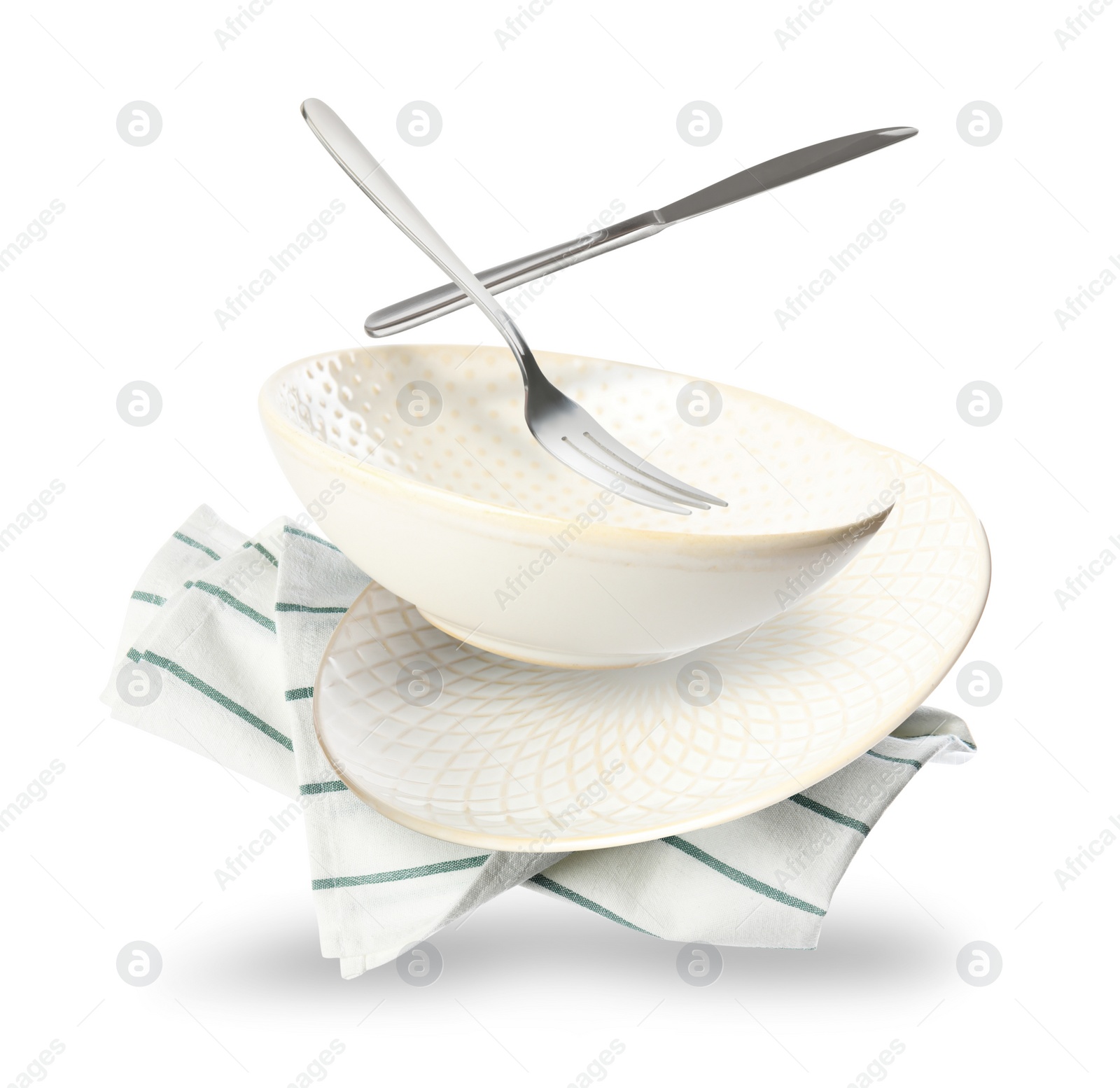 Image of Set of clean tableware and napkin in flight on white background