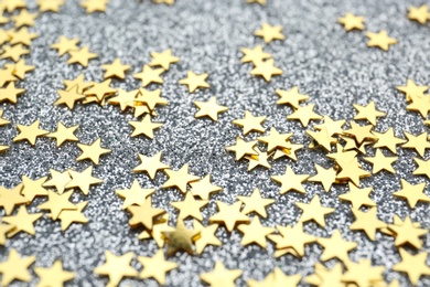 Confetti stars on grey background, closeup. Christmas celebration