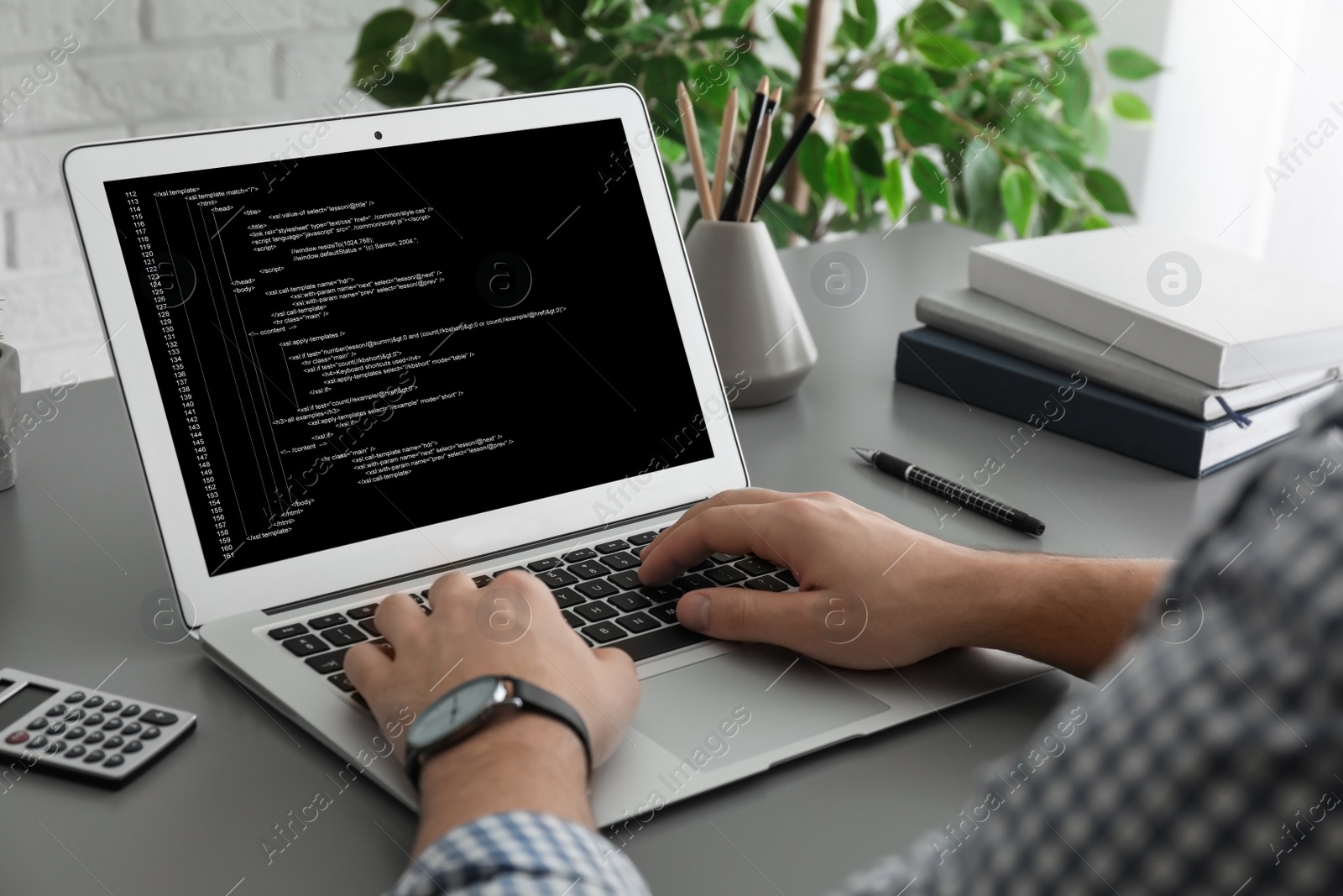 Image of Professional programmer working with laptop in office, closeup