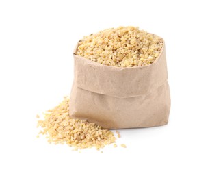 Photo of Raw bulgur in paper bag isolated on white