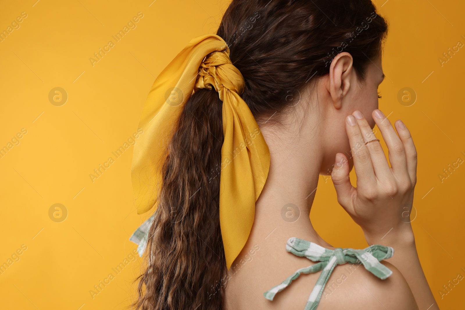 Photo of Woman with stylish bandana on yellow background