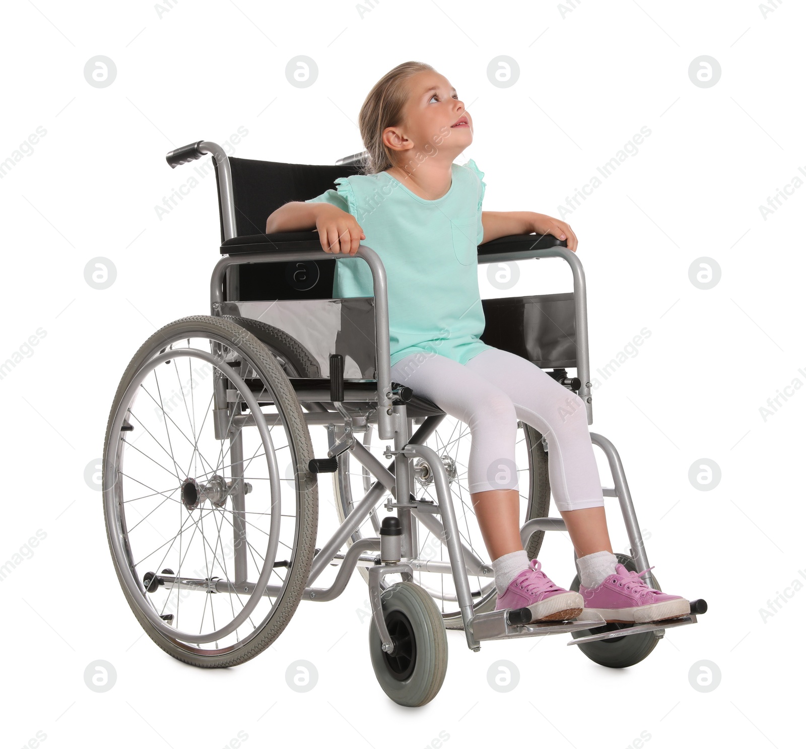 Photo of Little girl in wheelchair on white background