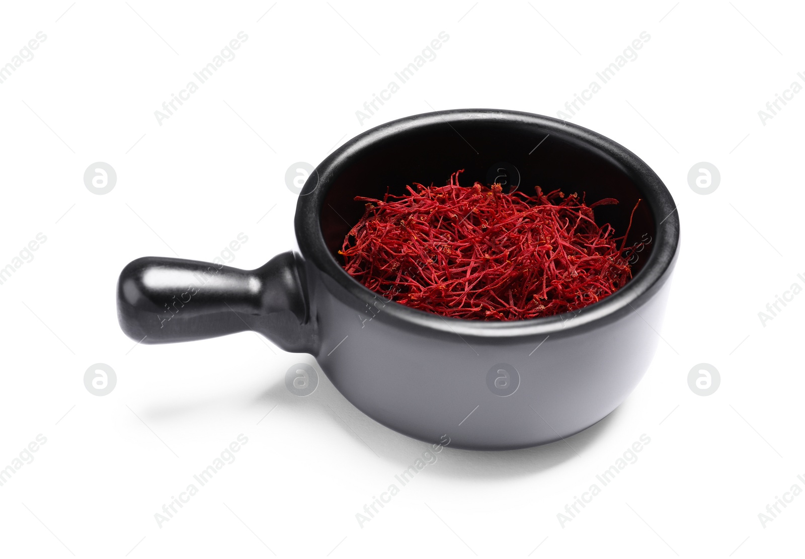 Photo of Aromatic saffron in dish isolated on white