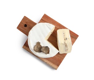 Wooden board with delicious truffle cheese isolated on white, top view