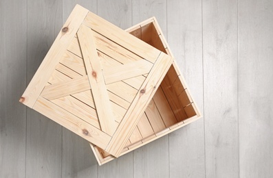 Photo of Open wooden crate on floor, top view