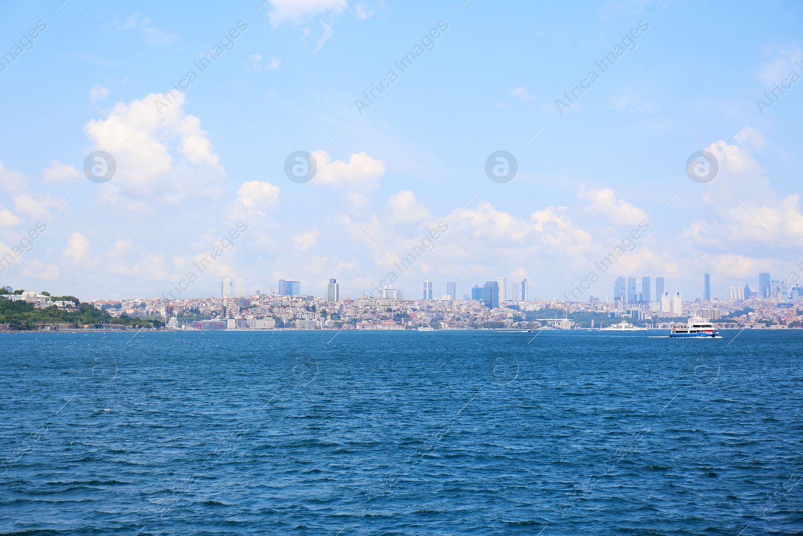 Photo of Beautiful view of ship in sea with city on background