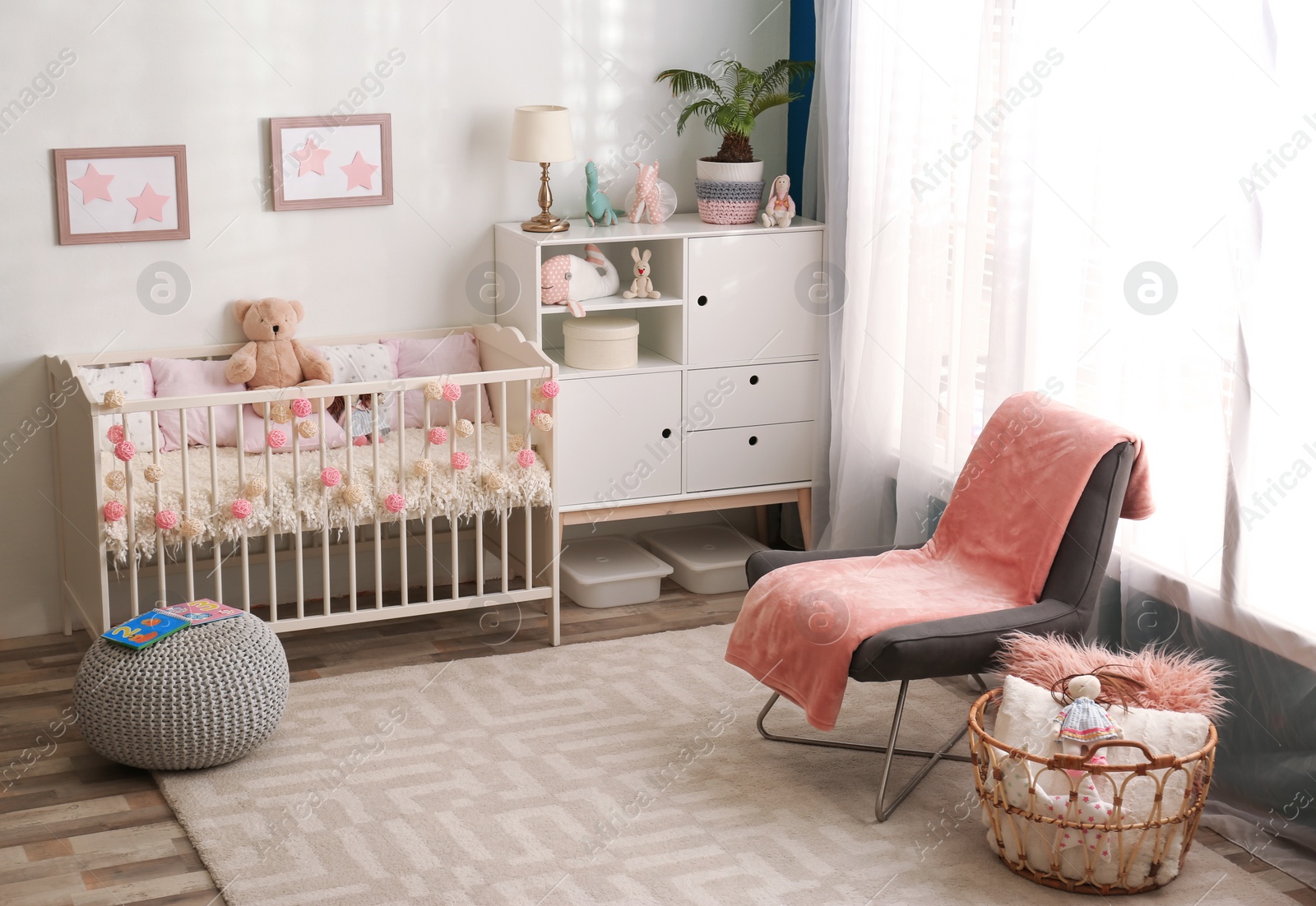 Photo of Cozy baby room interior with comfortable crib