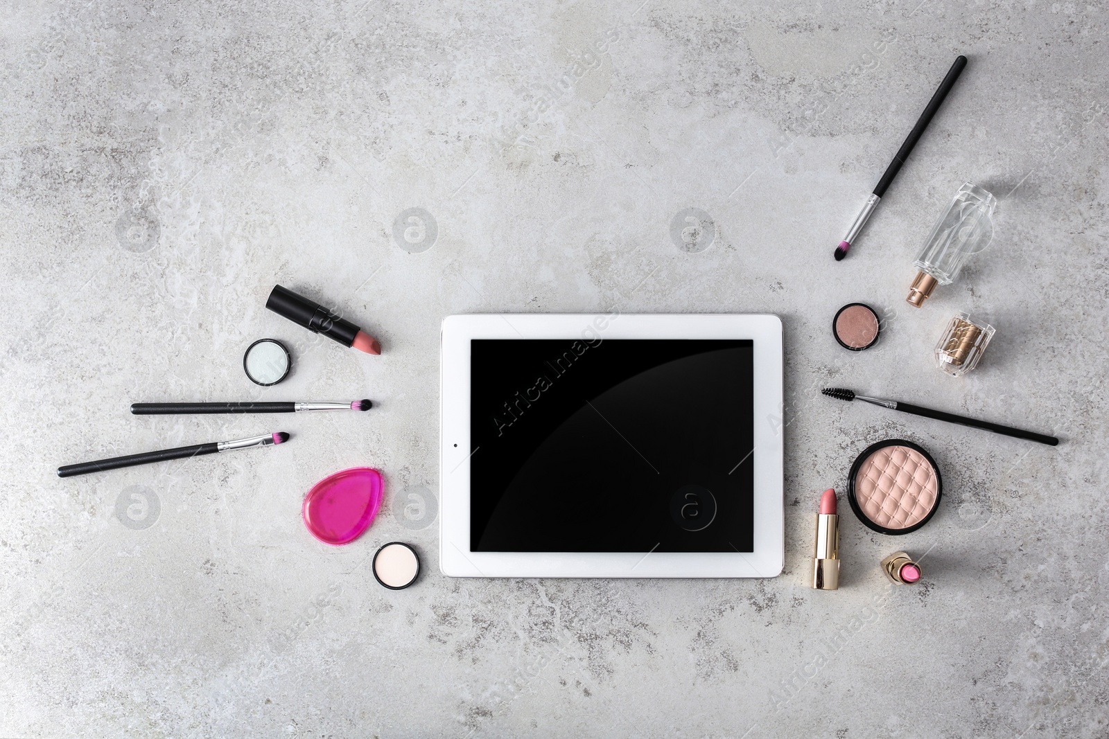 Photo of Makeup products for woman and tablet on gray background, top view